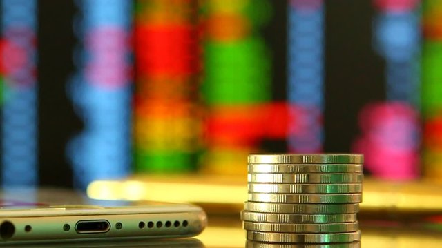 Coins  with stock exchange board background , in studio Chiangmai Thailand
