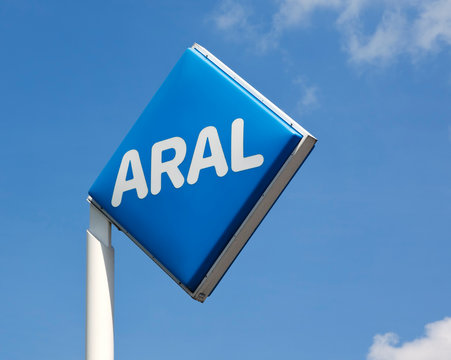 Hamburg, Germany - May 23, 2011: ARAL logo on post at a gas station against blue sky with small clouds.