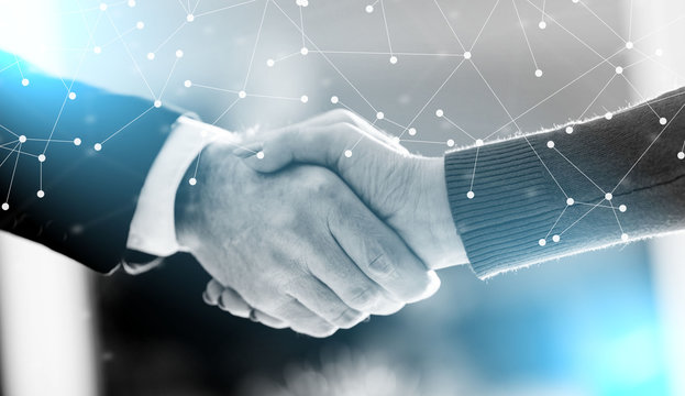 Business agreement with handshake; multiple exposure