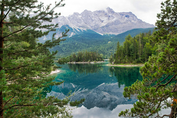 Fototapeta na wymiar Eibsee lake in front of Zugspitze mountain in Bavaria Germany. Gorgeous view. Alpine landscape with German Alps mountain Zugspitze 