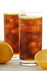 Glasses with cuba libre cocktail or cola with ice or cold tea with lemon