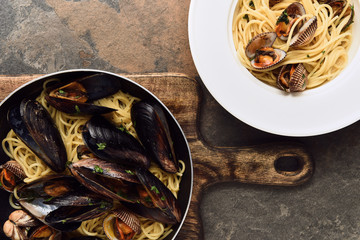 top view of delicious pasta with mollusks and mussels on weathered grey background