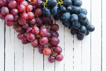red grapes variation on white wooden