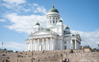  HELSINKI, FINLAND - JULY 27, 2019:  People on stairs of Helsinki Cathedral and monument to Russian...