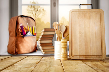 Wooden board and window background with school and kitchen accessories.