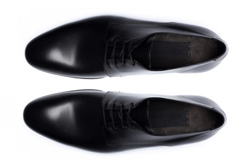 Classic male leather shoes isolated on a white, top view.
