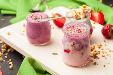 Healthy summer breakfast. Jar with granola, yoghurt and strawberry