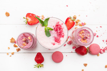 Strawberry with yogurt on white rustic wooden background. Cream dessert
