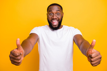 Photo of encouraged excited ecstatic afro guy seeing his favorite feline food discounted while isolated with vivid background