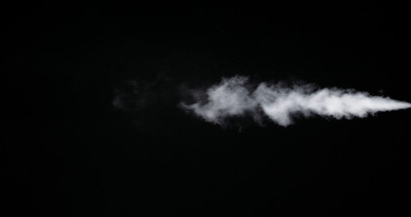 Fototapeta na wymiar White smoke trail isolated on black background.