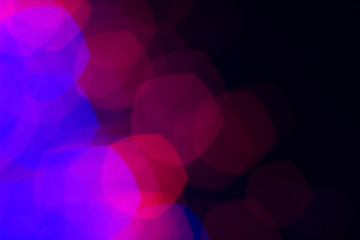 Blue bokeh lights on dark background; abstract background