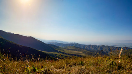 Panorama of a mountain valley in summer, aerial view. Fairytale sunset over the mountain peaks, amazing nature, summer in the mountains. Travel, tourism. beautiful background picture of nature