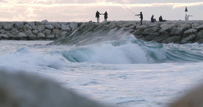 waves are battling the rocks in front of the embankments in south of france, mediterranean landsacape, mediterranean port and its lighthouse