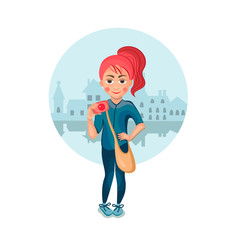 Cheerful girl with red hair holding hand camera.