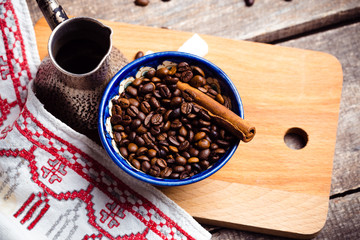 Fresh coffee in cezve on wooden table