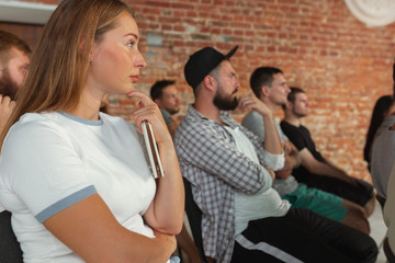 Group of students listen to presentation at university workshop. Audience or modern conference hall. Look insterested by, concentrated. Scientific conference event, training. Education concept.