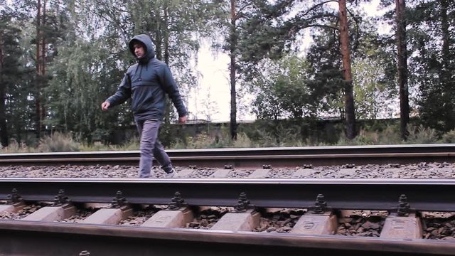 the guy crosses the railway track alone