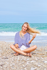 Fototapeta na wymiar Beautiful happy girl on the Adriatic beach. Travel and vacation.