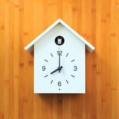 Isolated object, White vintage wall clock with birdhouse style on  wood panel background