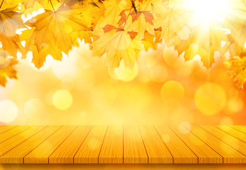 Naklejka na ściany i meble Wooden table with orange fall maple leaves. Autumn natural background