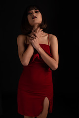 Fototapeta premium Southeast asian woman with dark tone makeup on black background, portrait photography