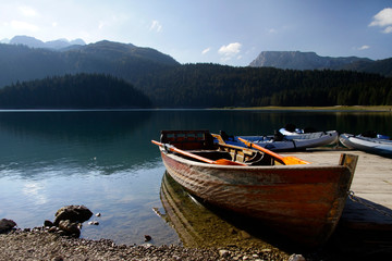 Rowing boats and canoes at a pier at the Black Lake, Montenegro