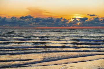 Sunset with waves on the Baltic Sea