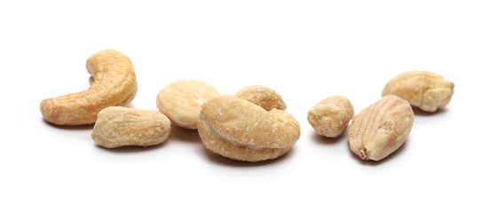 Mix of roasted, salted peanuts, cashew nuts and almonds isolated on white background