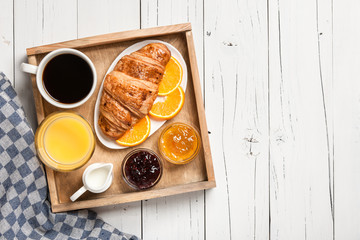 Breakfast with coffee, orange juice jam and fresh croissant