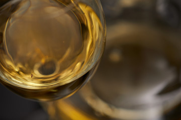 A glass full of wine and wine decanters