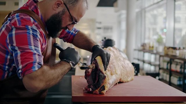 Chef cutting beef carcass in a restaurant