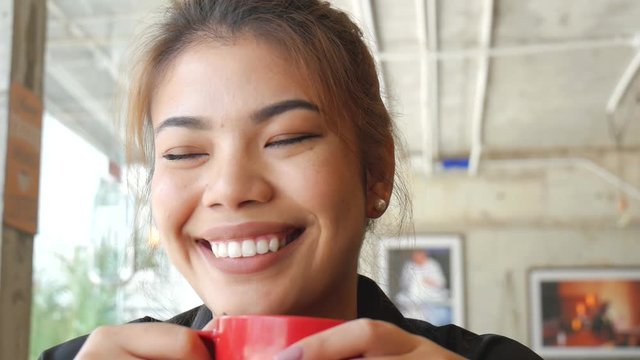 Happy Asian woman drinking coffee and work at café, lifestyle concept.