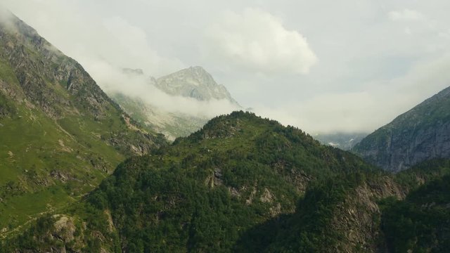 Drone shot of huge mountains in the French Pyrenees, top shot of a big forest, Beautiful environnement aerial cinematography