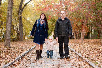 Fototapeta premium Family with a little toddler kid walkin