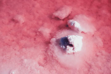 Obraz premium Textured of different shapes of rocks of salt in a pink water basin.