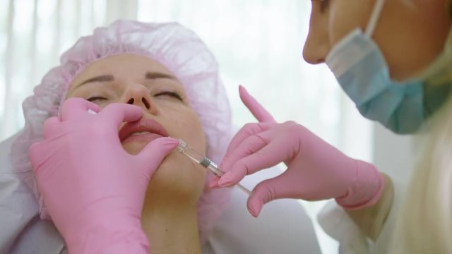 Woman getting treatment with injectable hyaluronic acid dermal filler