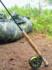  Fishing rod with spinning. Fishing equipment. Stick of balsa wood. Fishing rod with a coil lying...