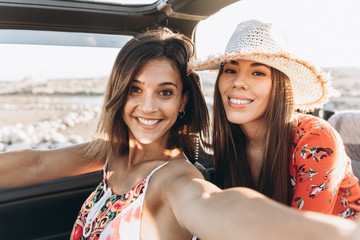 cute friends enjoying a sunset on the beach