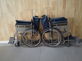 Two blue wheelchairs parking in hospital lobby