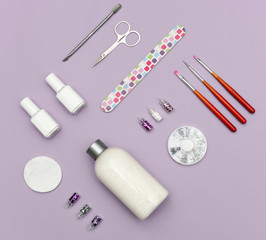 A set of cosmetic tools for manicure and pedicure on a weyt background.