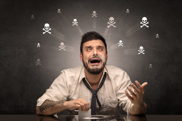 Loser drunk man sitting at table with skulls concept around