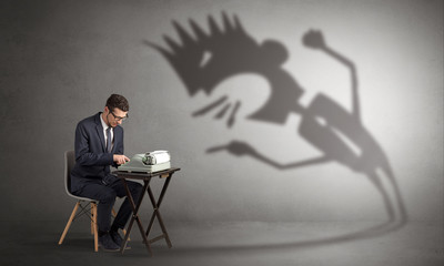 Man working hard and he is afraid of a yelling shadow