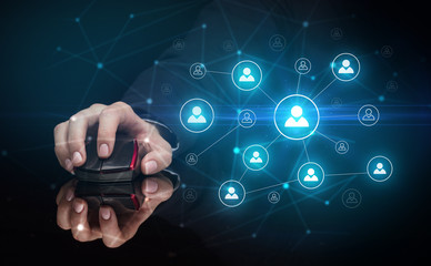 Hand using wireless mouse in a dark environment with human network concept