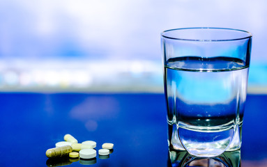 Glass of water and pills