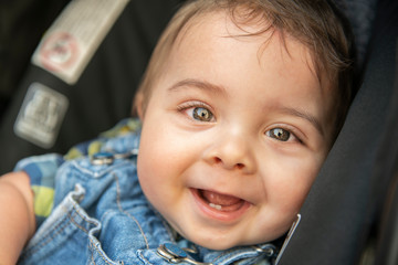 Cute 9 months old baby in car child seat