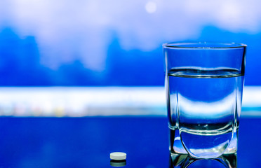 Glass of water and pills