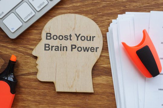 Writing note showing Boost Your Brain Power. Conceptual photo shows the work of the brain. Keyboard, markers, notebook, wooden background are on the photo too.
