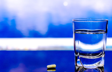 Glass of water and pill