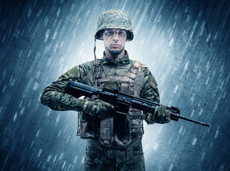 Armed soldier standing in rainy weather