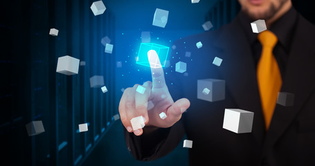 Man touching hologram screen displaying cube symbols